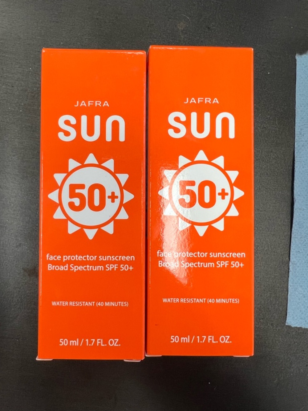 JAFRA Sun Face Protector SPF 50+ — Bright Orange & White Packaging
